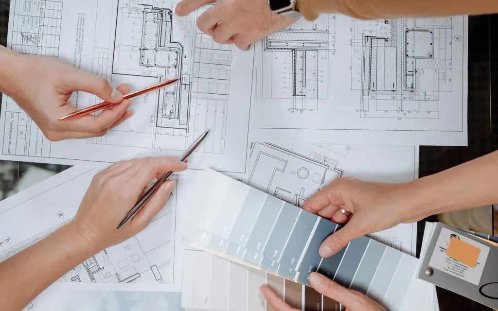 Architectural team coordinating technical drawings and facade material samples